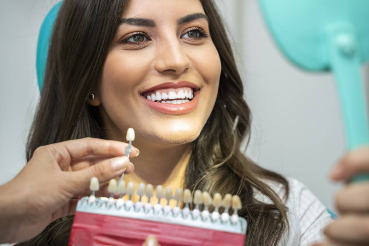Stock image of a girl in dental clinic checking for tooth replacement options