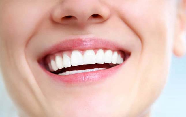 Stock image of a girl smiling teeth focused