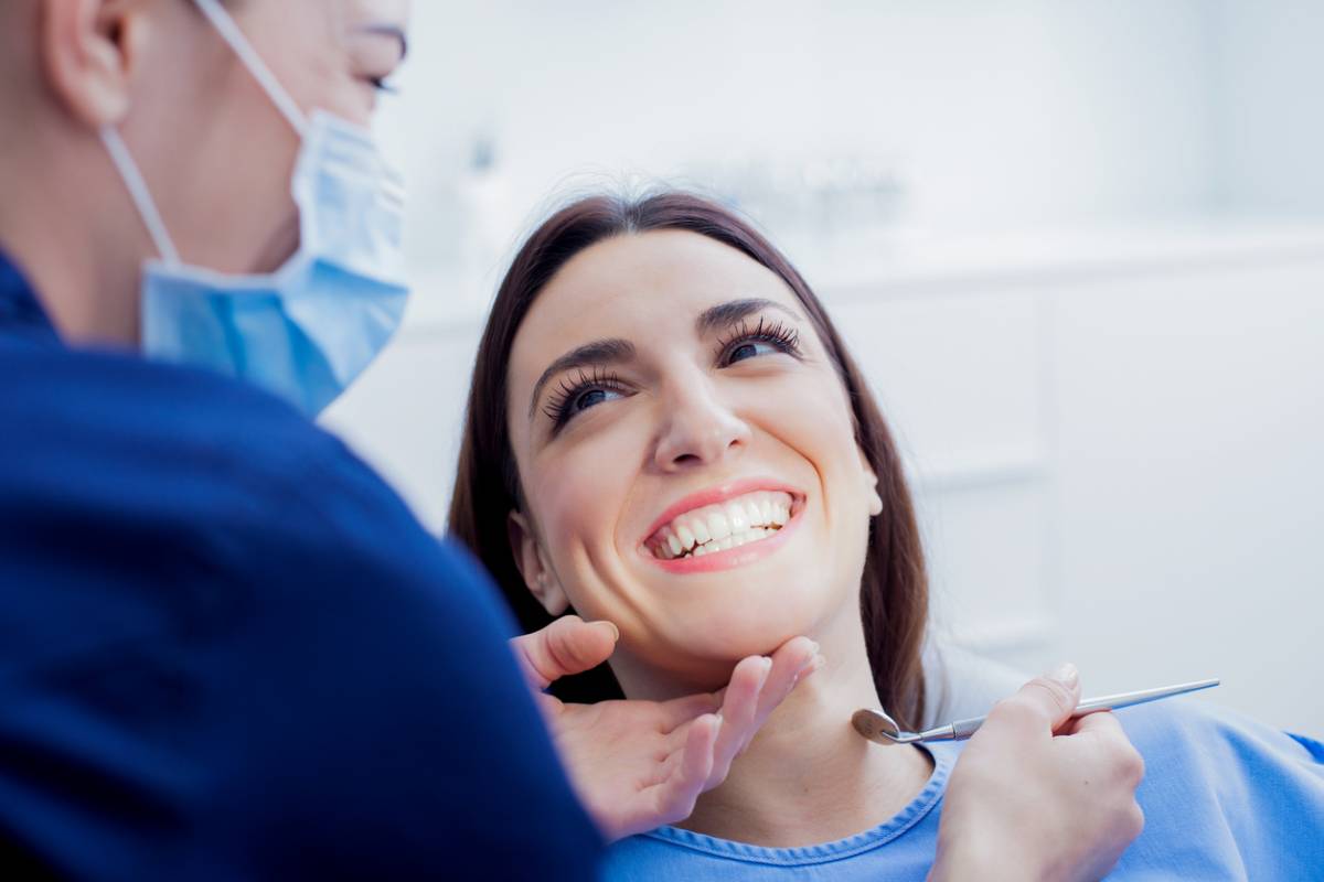 woman at dentist having regular teeth cleaning